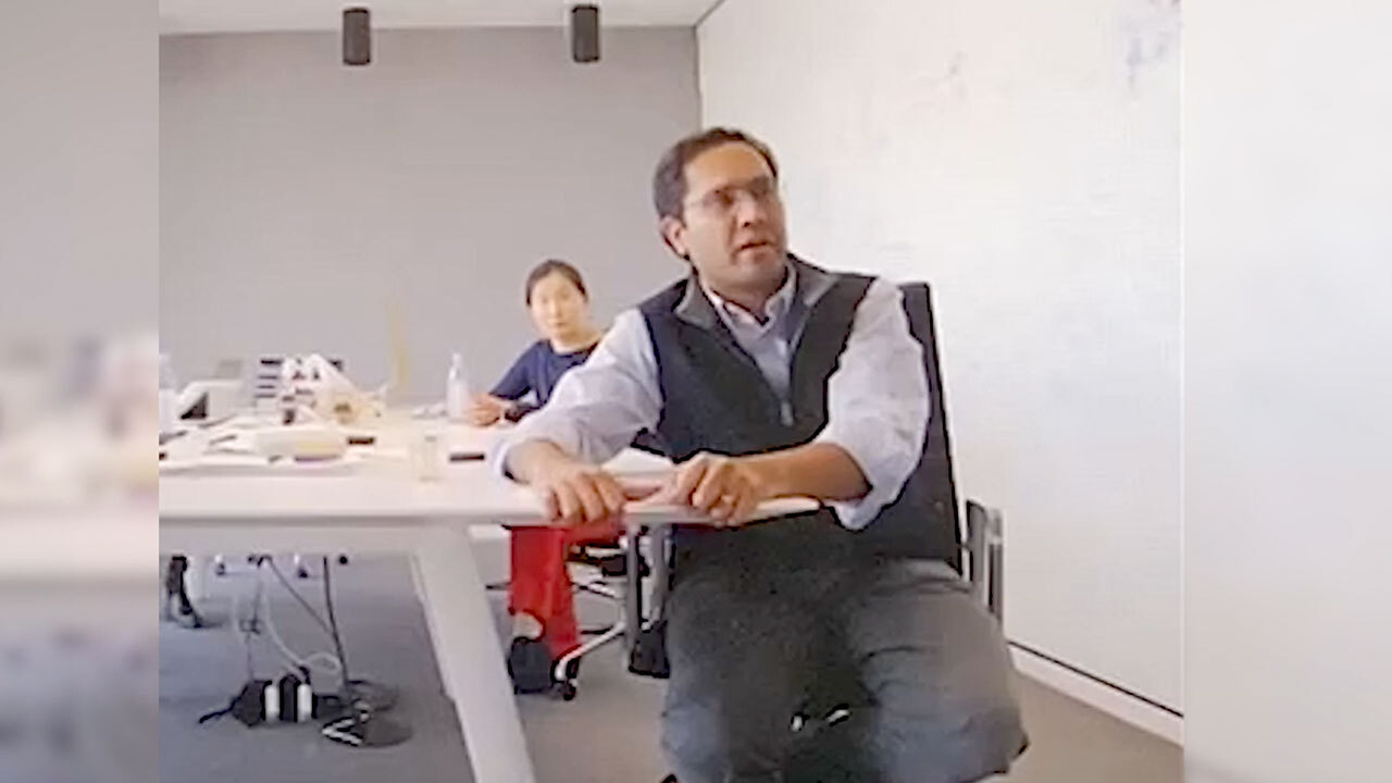 Two men sitting at a conference table.