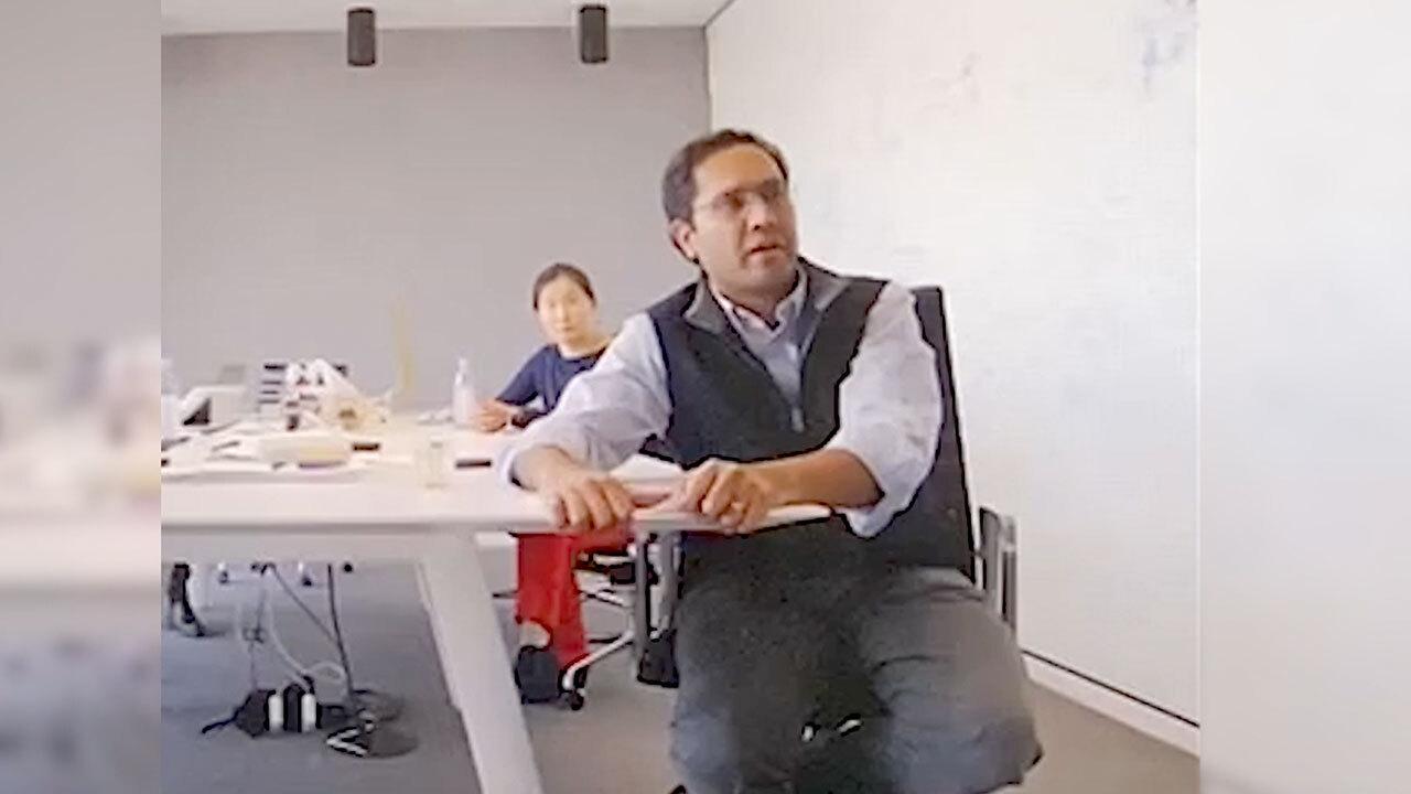 Two men sitting at a conference table.