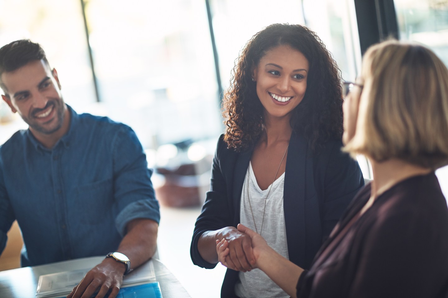 Shot of two businesswomen shaking hands during a meeting in a modern office