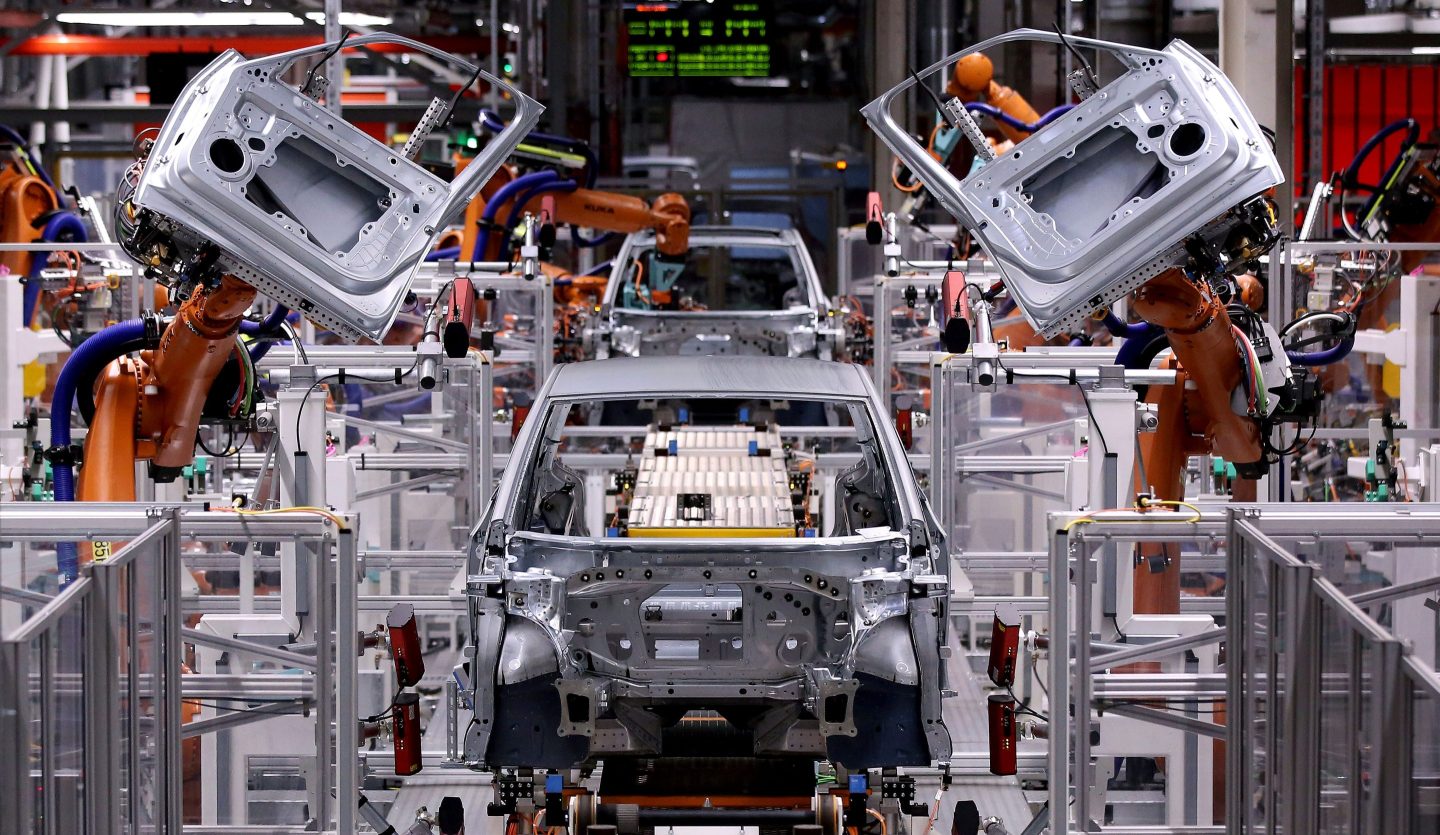 Robotic arms mount doors to a model of the ID.3 Volkswagen electric car at an assembly line of the car factory of German car maker Volkswagen (VW) in Zwickau, eastern Germany, on February 25, 2020.