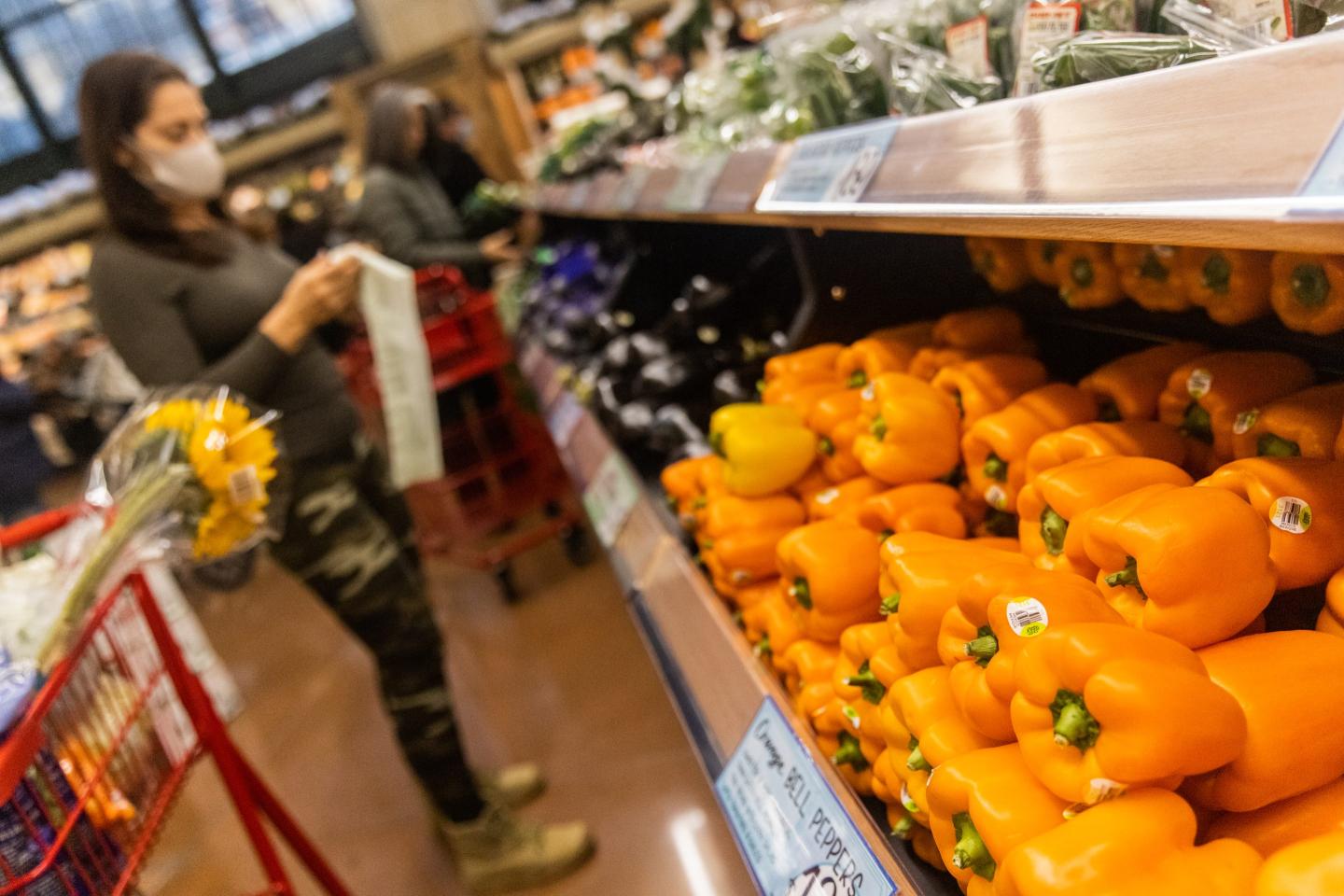 Shopper picks up produce in a Trader Joe's store in New York City.