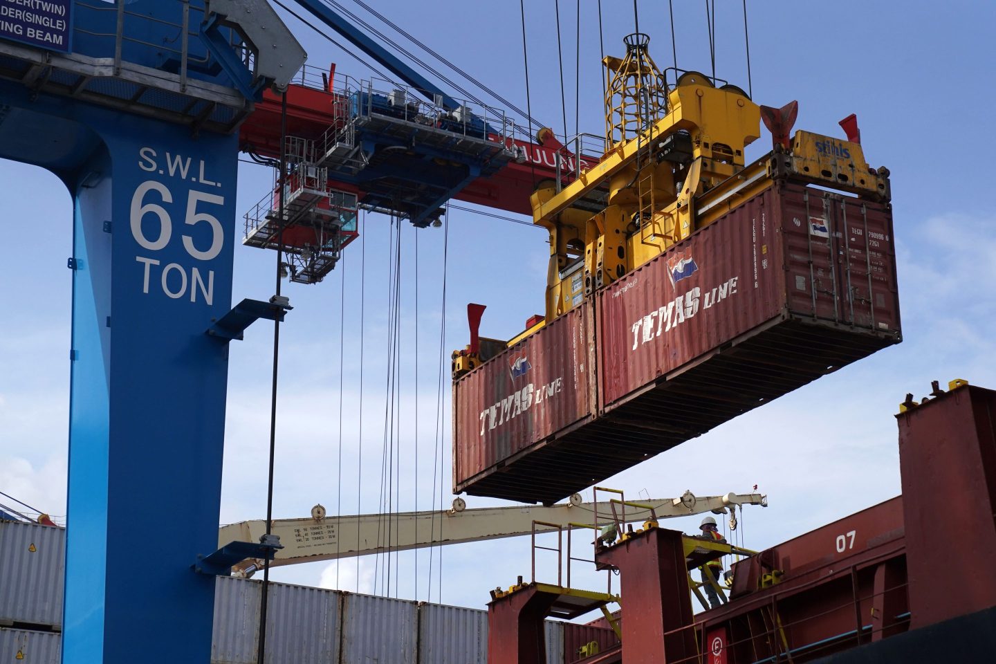 A shipping container is moved by a gantry crane in the IPC Container Terminal at Tanjung Priok Port in Jakarta, Indonesia, on Friday, Dec. 10, 2021.
