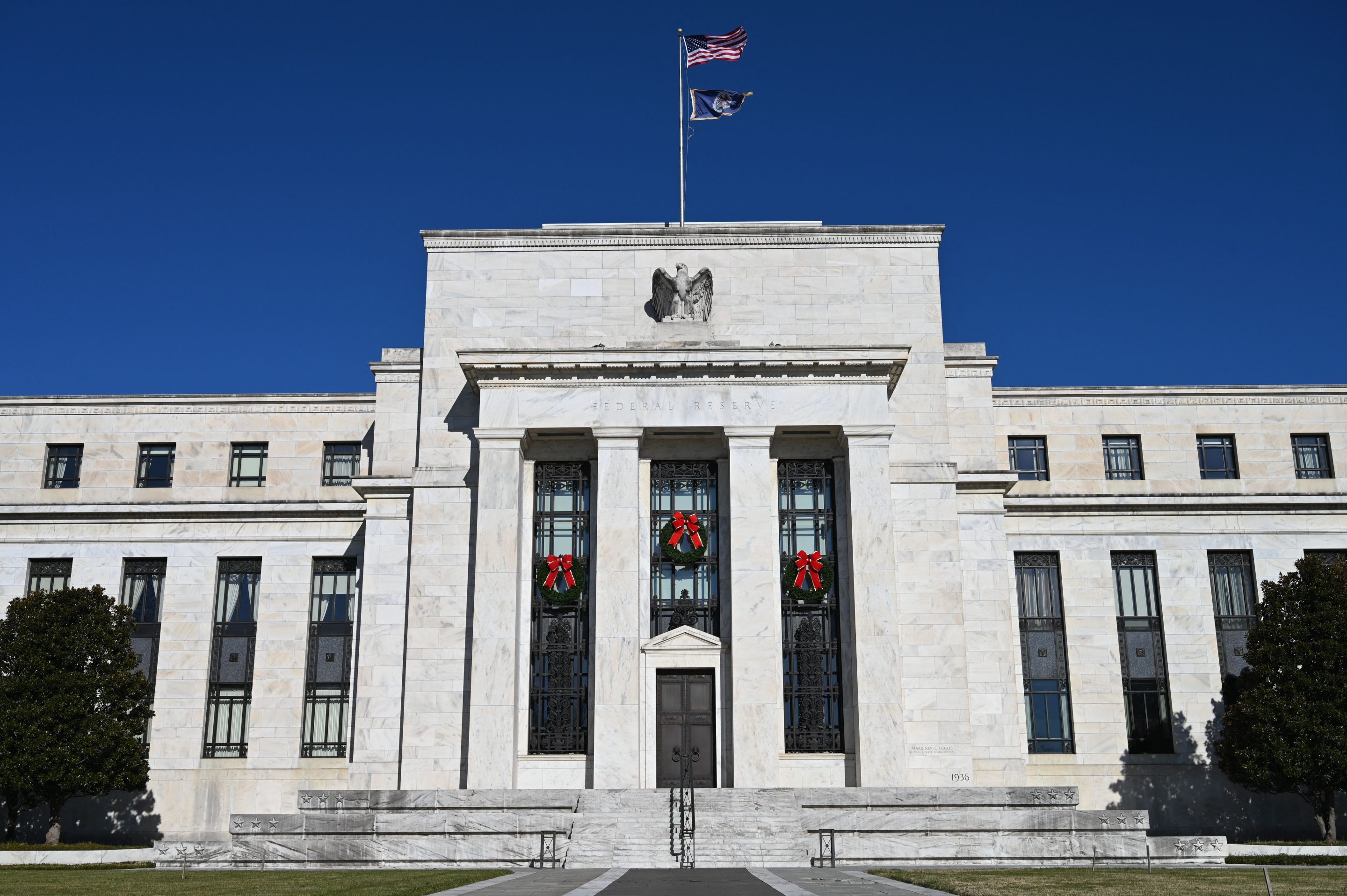 The Federal Reserve moves to dial back bond buying and predicts several 2022 rate hikes as inflation rises. 