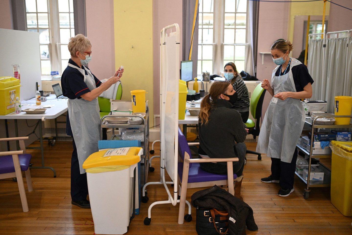 Woman waiting to receive a vaccine booster shot.