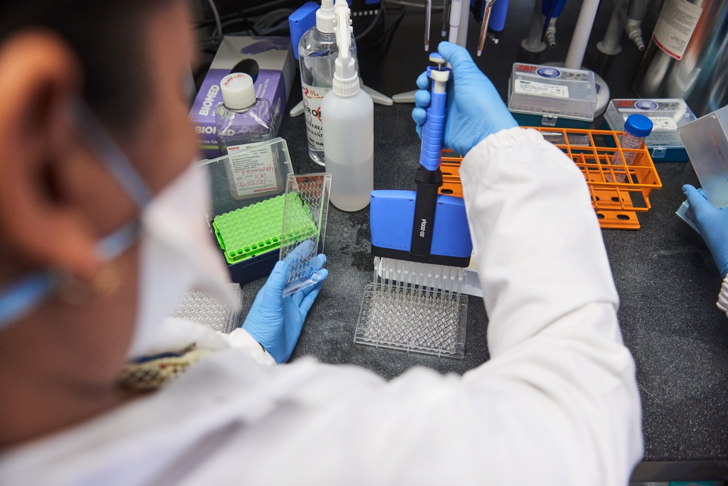 A technician uses a multi-channel pipette dropper to dispense material during Covid-19 antibody neutralization testing in a laboratory at the African Health Research Institute (AHRI) in Durban, South Africa, on Wednesday, Dec. 15, 2021. South Africas hospital admission rate as a percentage of new Covid-19 cases identified dropped sharply in the second week of the current infection wave driven by the omicron variant, compared with the same week of the third wave. Photographer: Waldo Swiegers/Bloomberg via Getty Images