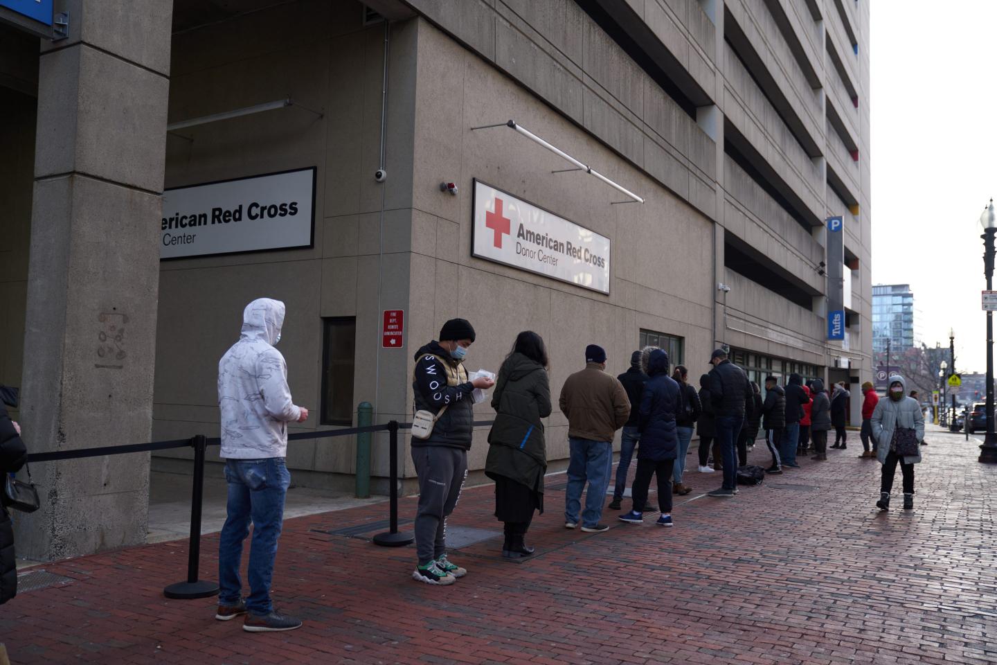 Boston residents wait in line to receive a COVID-19 test.