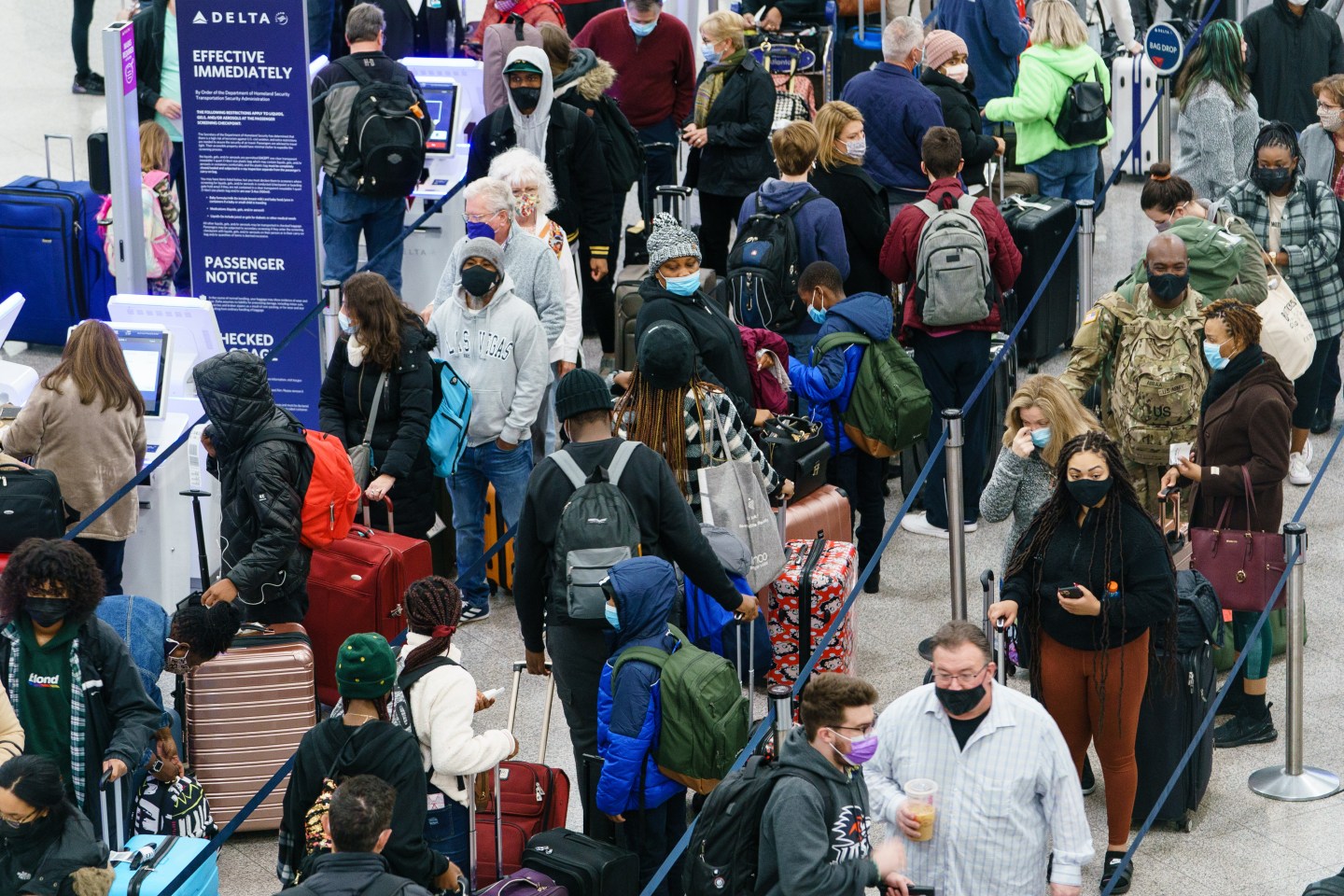 Travelers wait to check in at the airport in Atlanta.