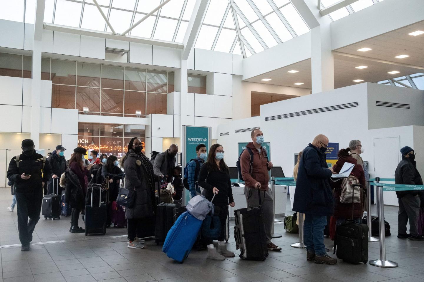 Travelers on line at LaGuardia Airport in New York City.