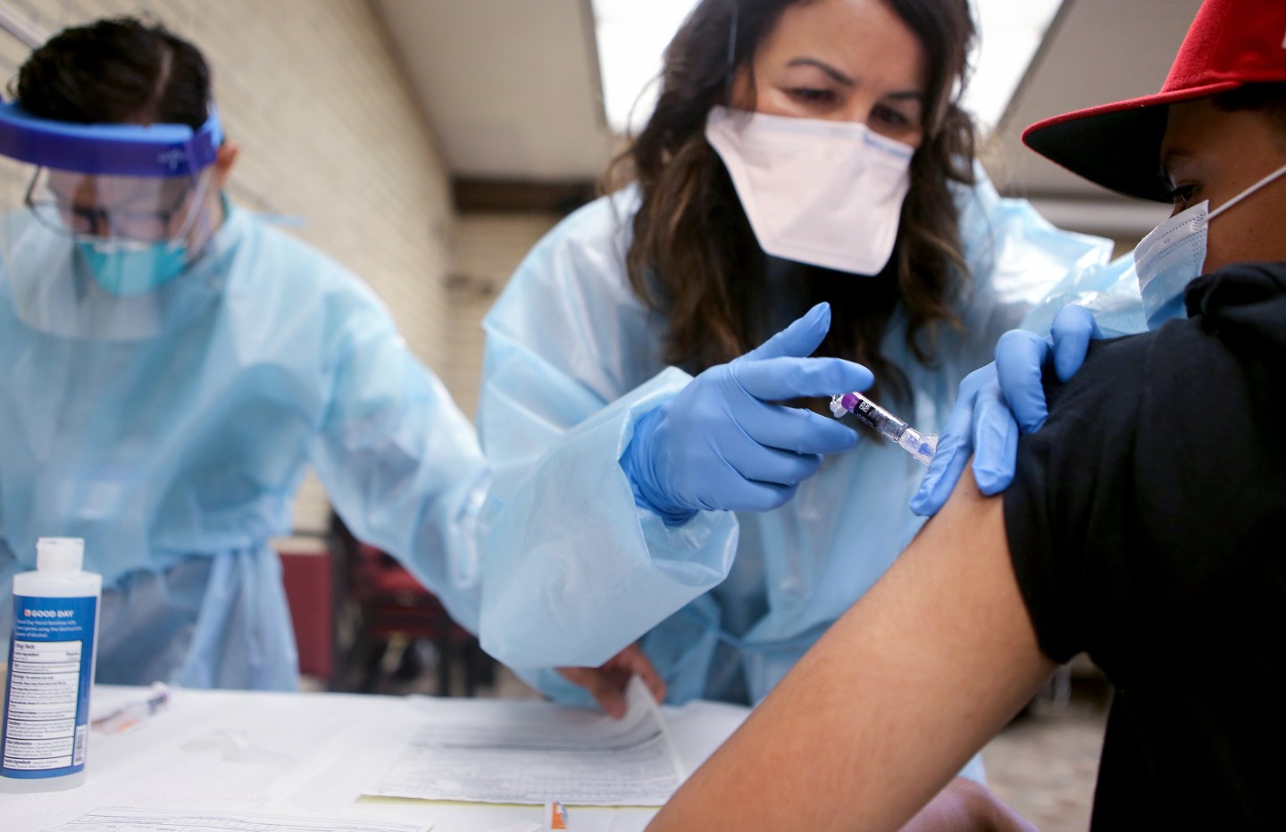 A woman nurse giving a flu shot.