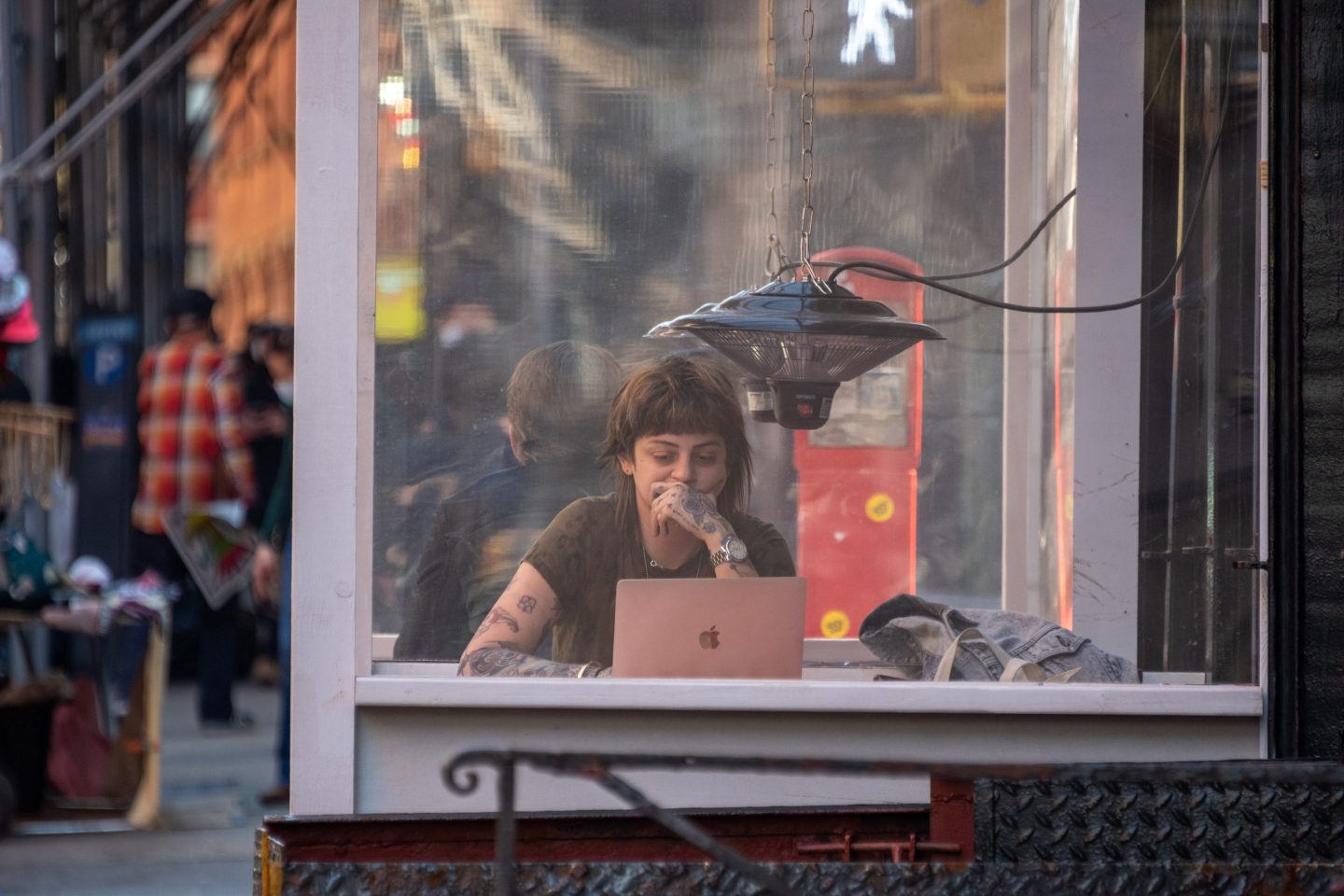 A woman works on a laptop at a restaurant.