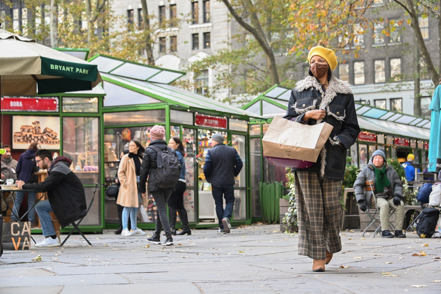 People shop at an outdoor holiday market in New York City.
