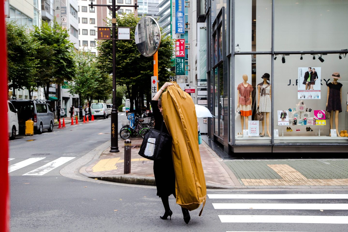 A young lady takes her clothes from a laundry store in Ginza