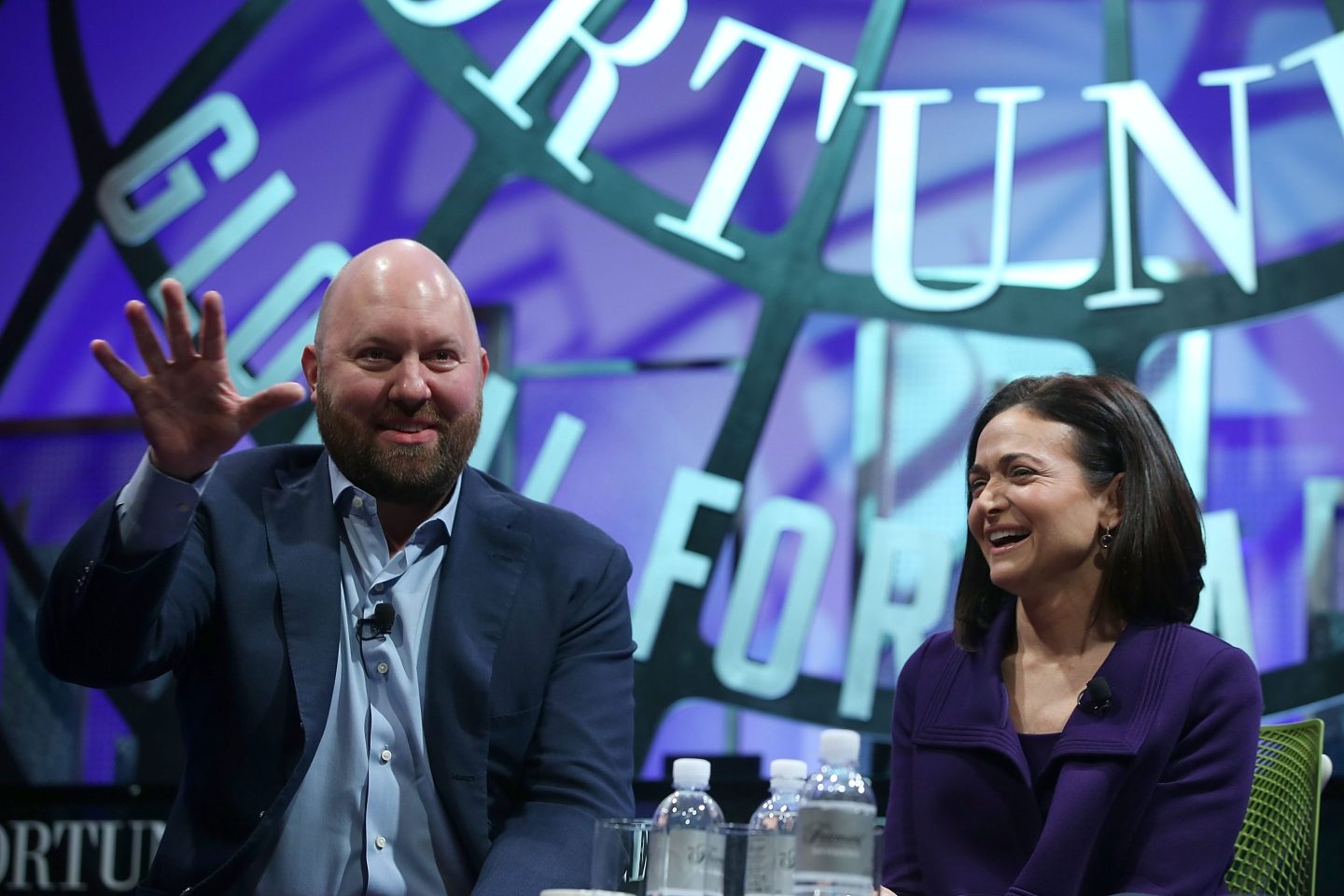 Two people speaking at a conference.