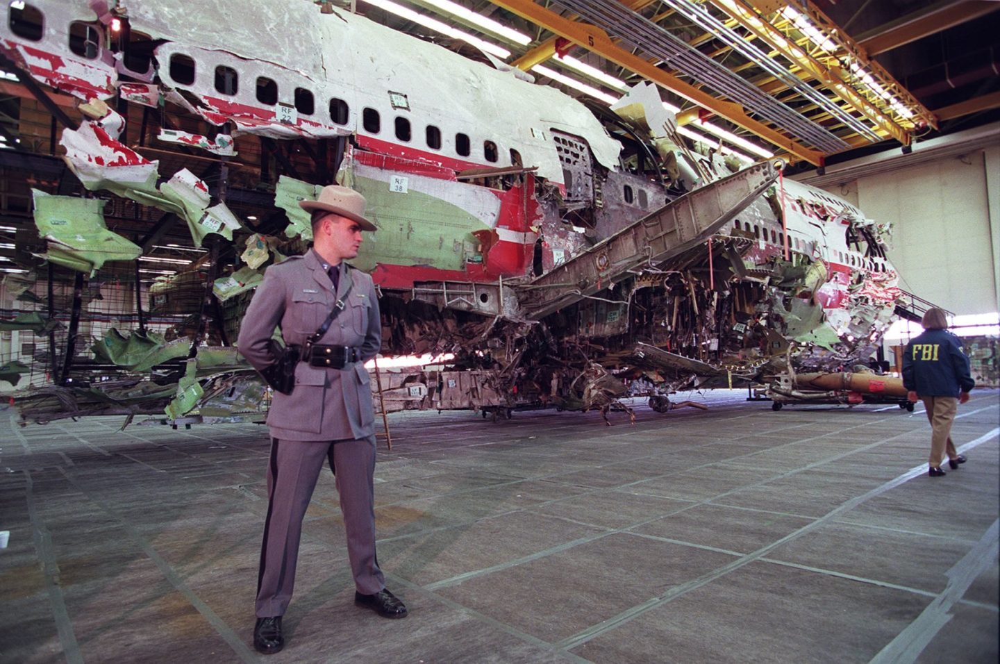 A New York State trooper stands guard in front of the reconstructed wreckage of TWA flight 800 in Calverton, on Long Island, N.Y. The crash was one of the high-profile accidents that compelled the airline industry to share data in the 1990s.
