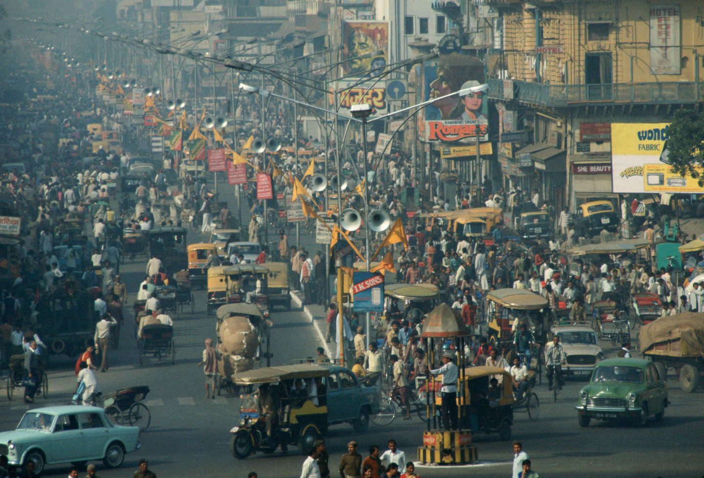 INDIA - JANUARY 01: People, rickshaws and cars in a crowded busy street in rush hour, Delhi, India.