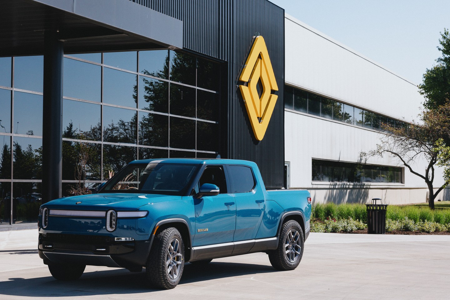 A blue pickup truck outside the assembly plant.