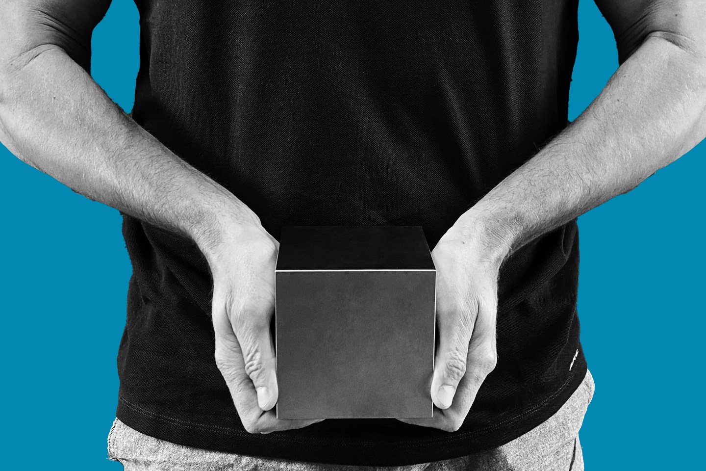 man holding a tungsten cube