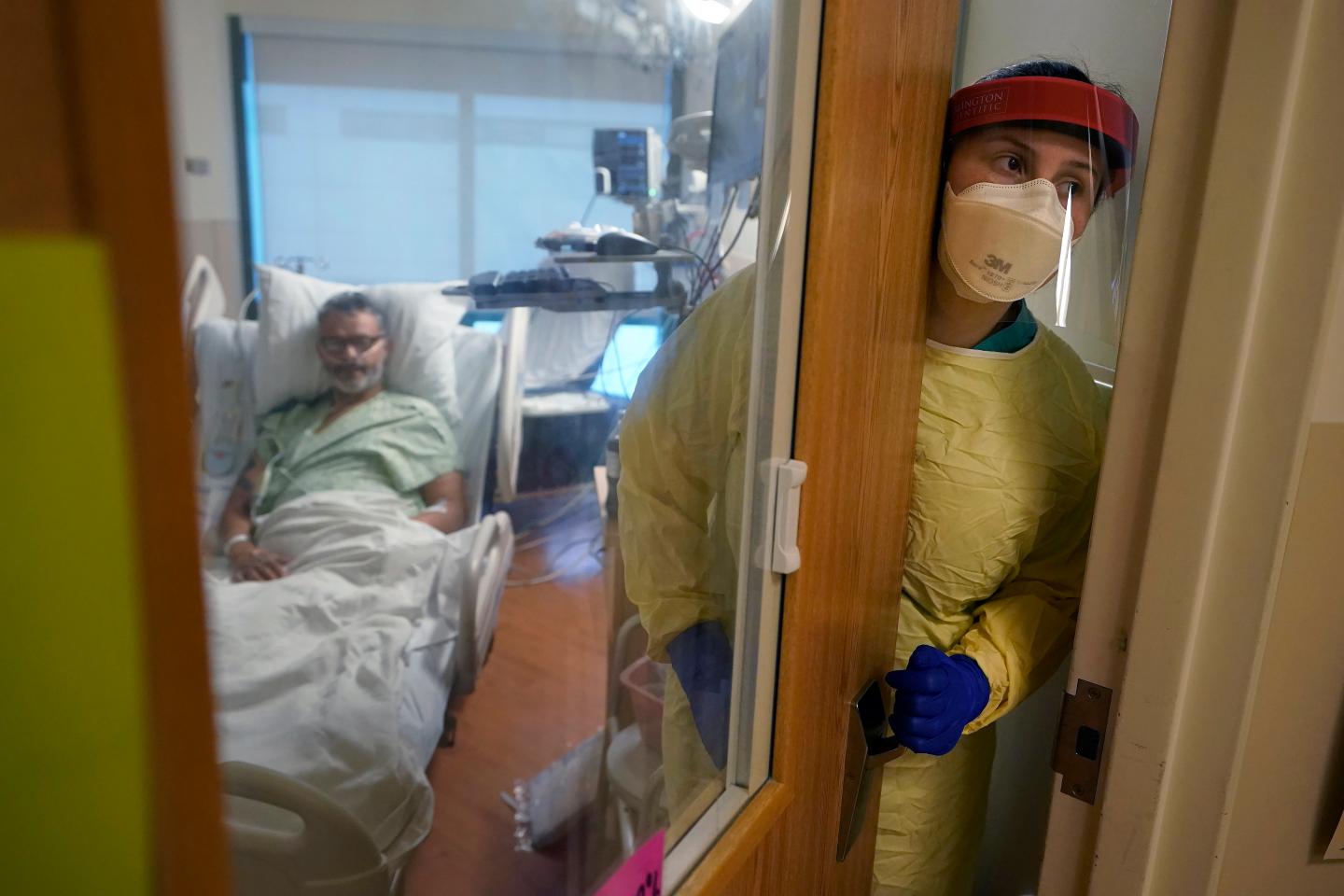 A nurse attends to a COVID patient.