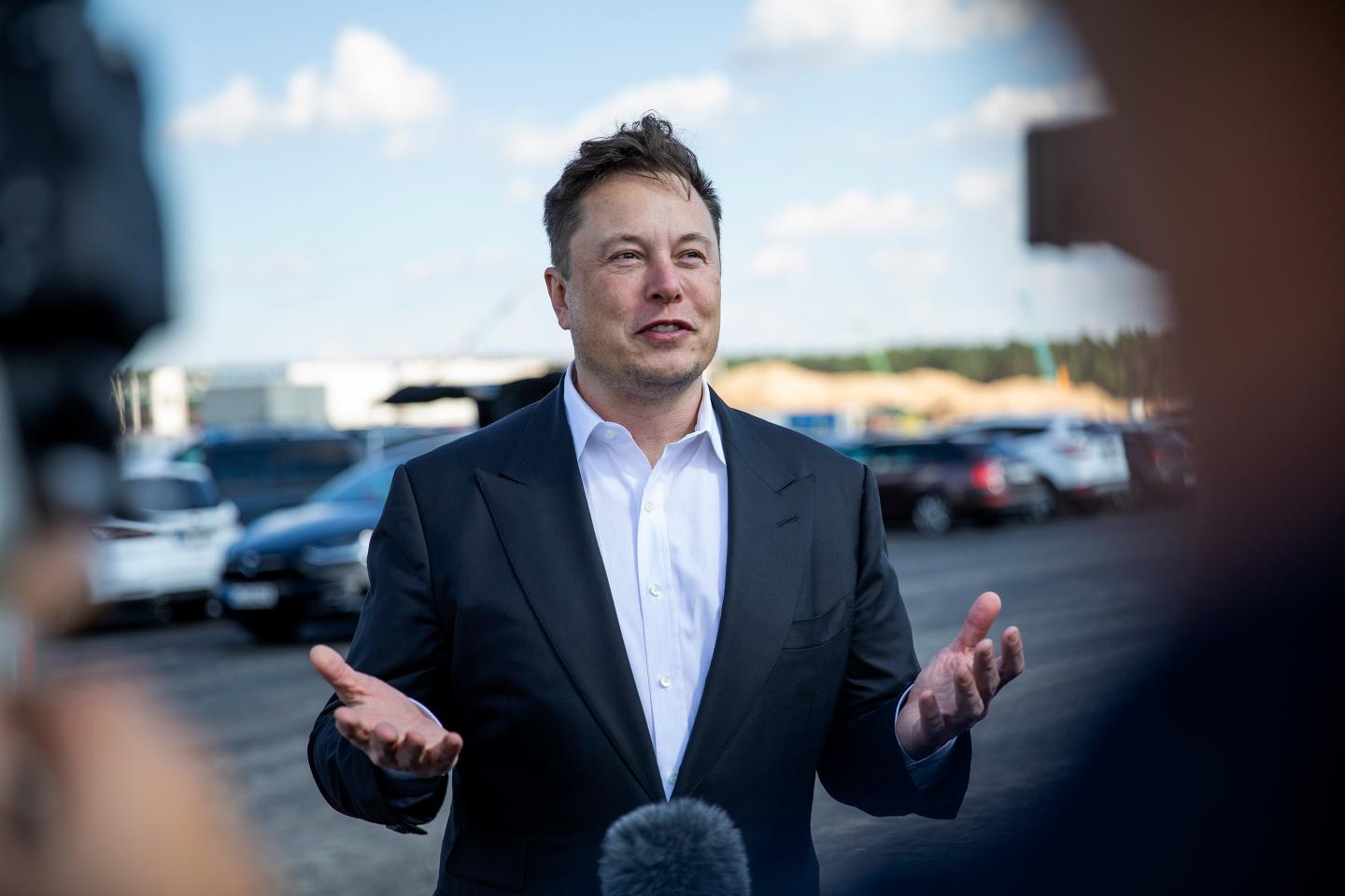 Tesla head Elon Musk talks to the press as he arrives to to have a look at the construction site of the new Tesla Gigafactory.
