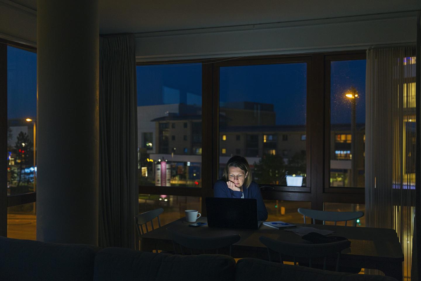 Woman working from home late at night