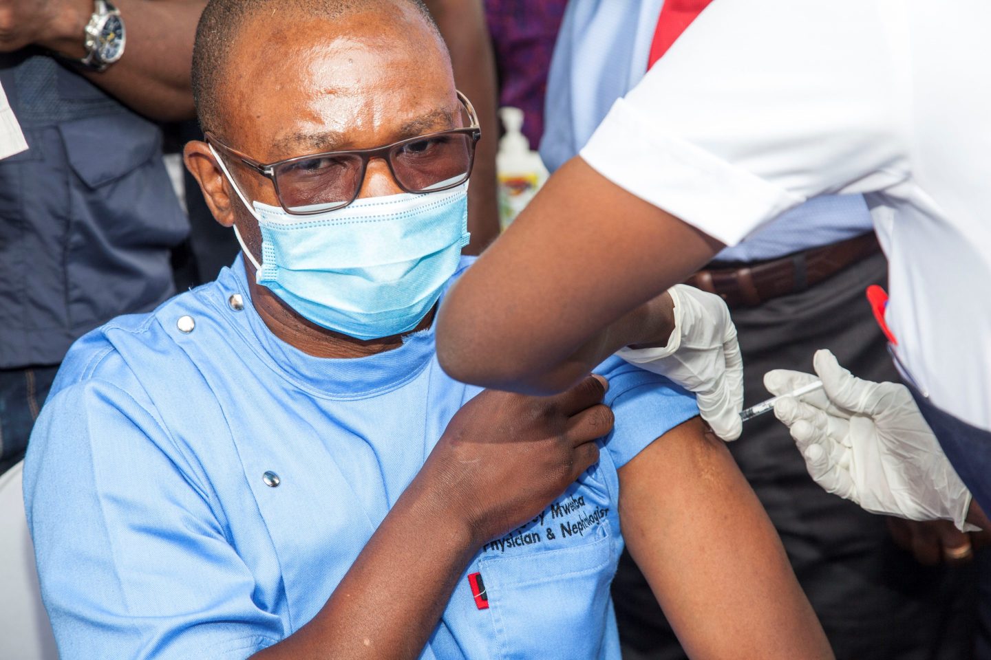 A front-line medical worker receives the COVID-19 vaccine at a hospital in Lusaka, Zambia. "If we want to stop the spread of COVID, we need to make it easier and cheaper for people everywhere to get access to diagnostics," writes Jennifer Lotito.