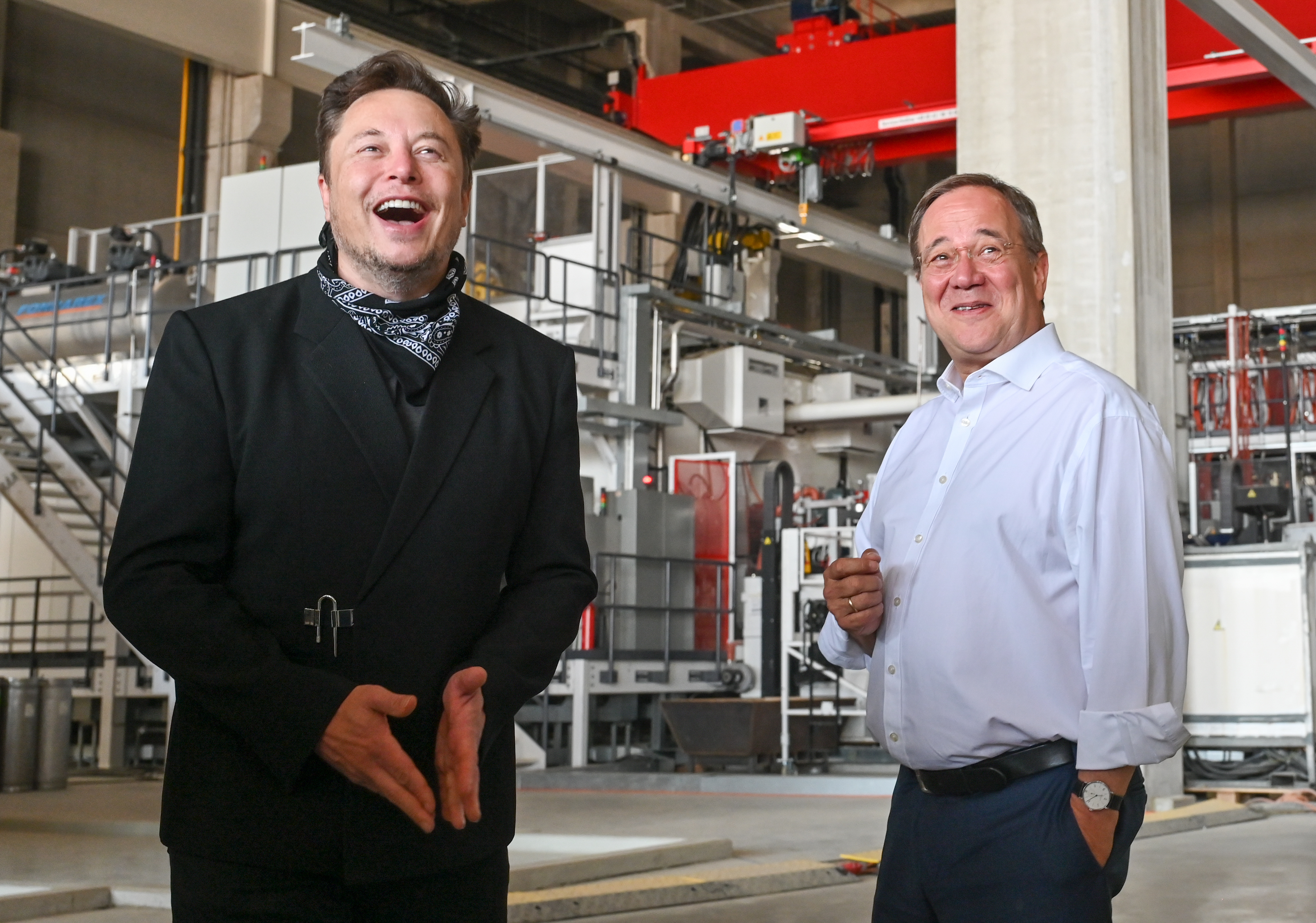 Tesla CEO Elon Musk and Armin Laschet, then CDU federal chairman and minister president of North Rhine–Westphalia, talk during a tour of the plant housing the future foundry of Tesla’s Gigafactory on Aug. 13, 2021, in Grünheide, near Berlin.