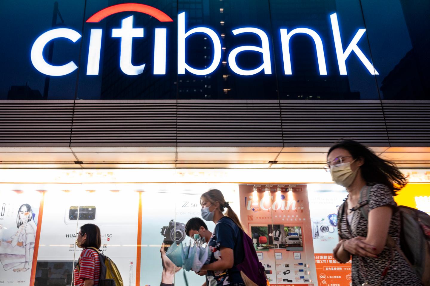 People walk by a Citibank branch in Hong Kong.