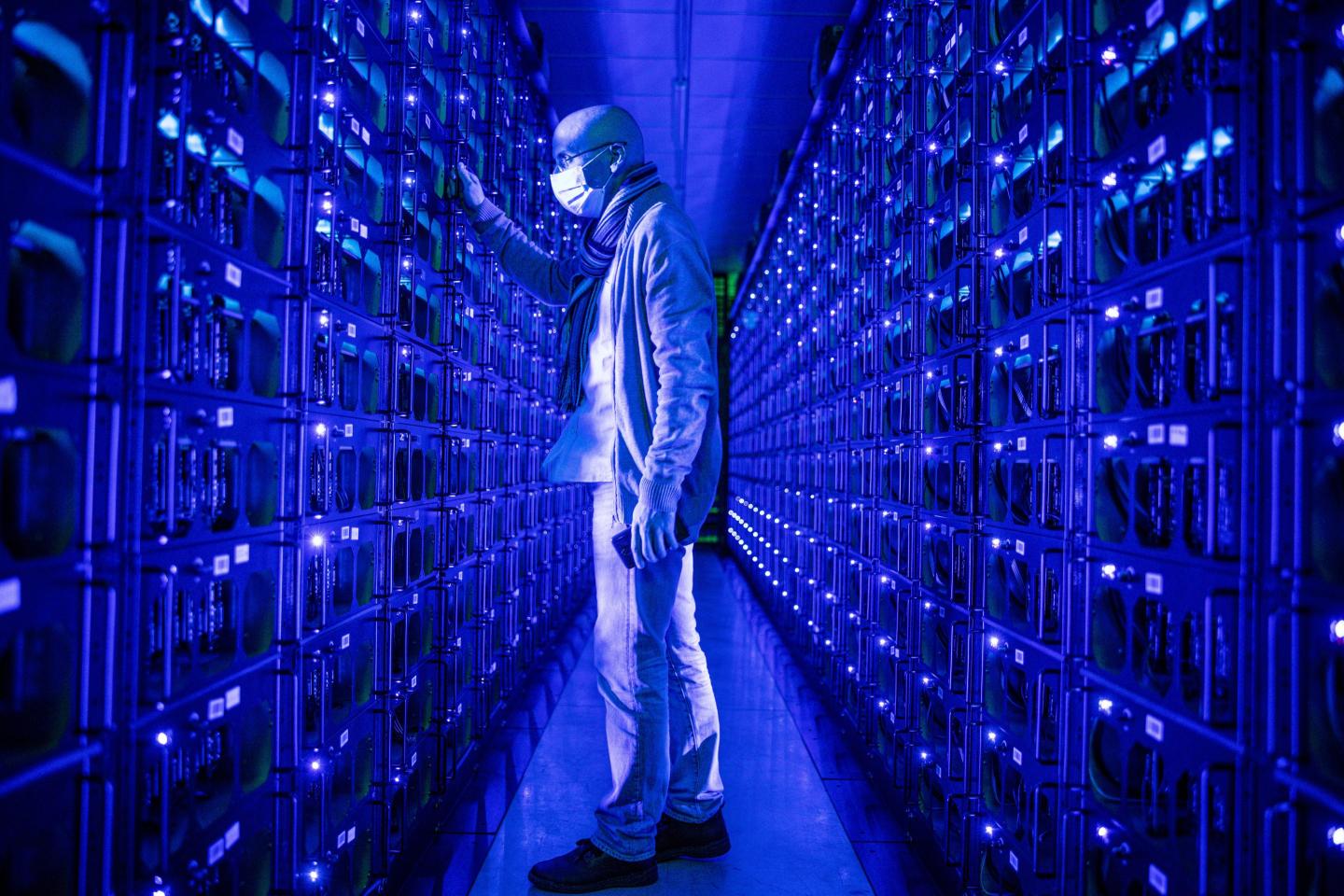 a man in a room in blue light