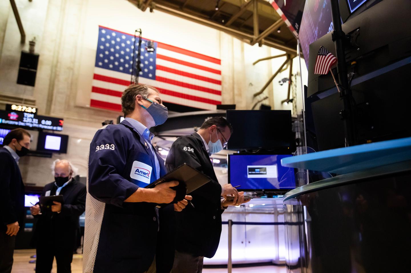 Traders work on the floor of the New York Stock Exchange (NYSE) on Monday, Jan. 3, 2022.