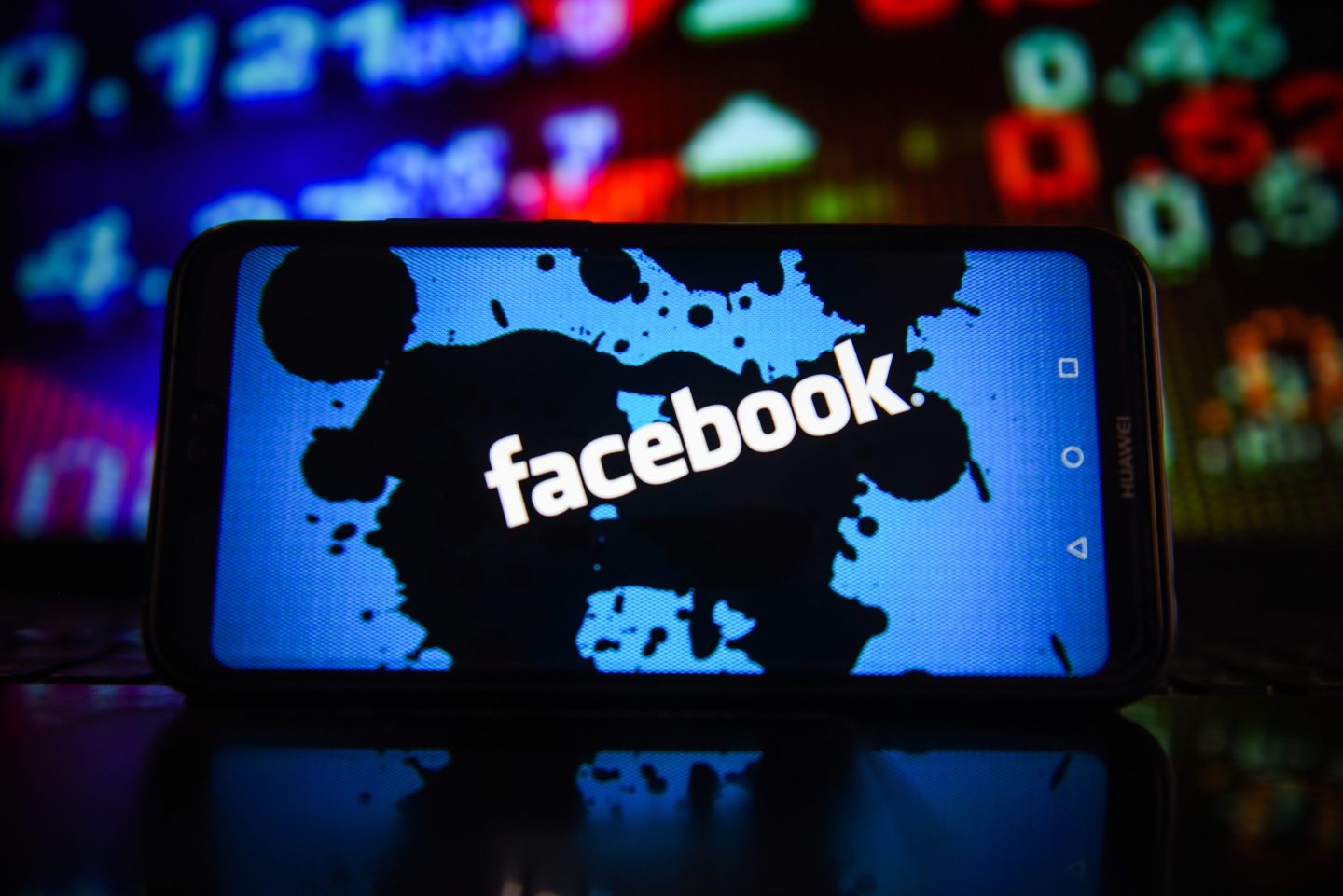 In this photo illustration, the Facebook logo is seen on a screen.