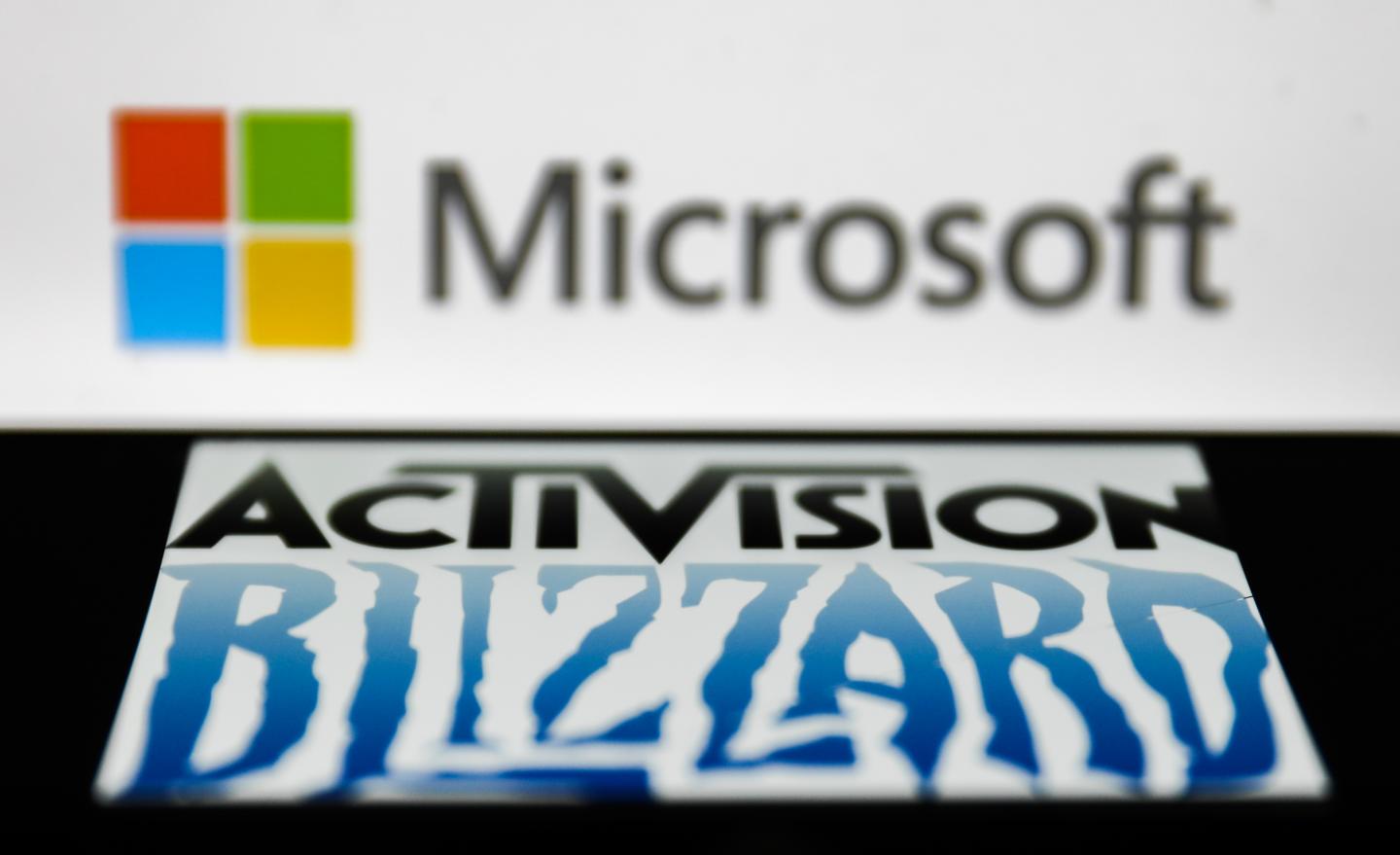 Activision Blizzard logo displayed on a phone screen and Microsoft logo displayed on a laptop screen are seen this illustration photo taken in Krakow, Poland on January 18, 2022.