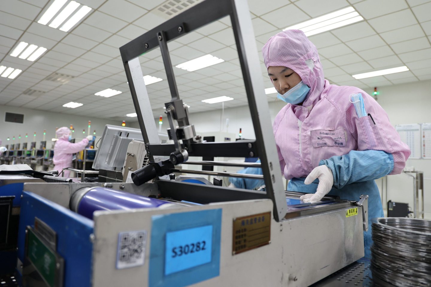 An employee works at a semiconductor manufacturer