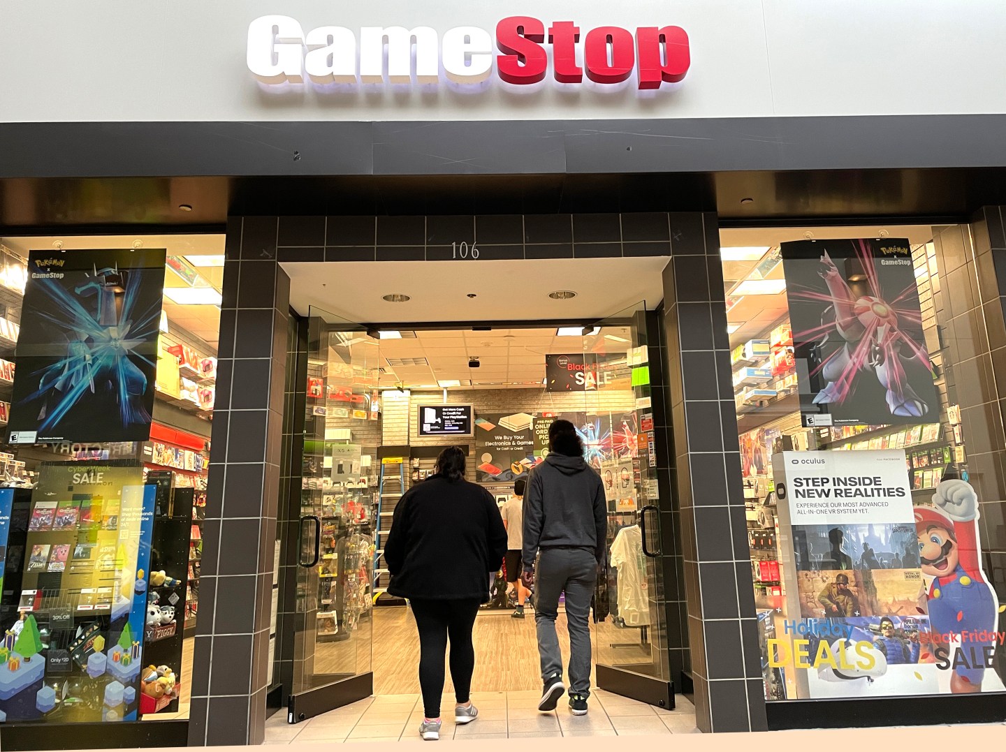 Shoppers entering a GameStop location.
