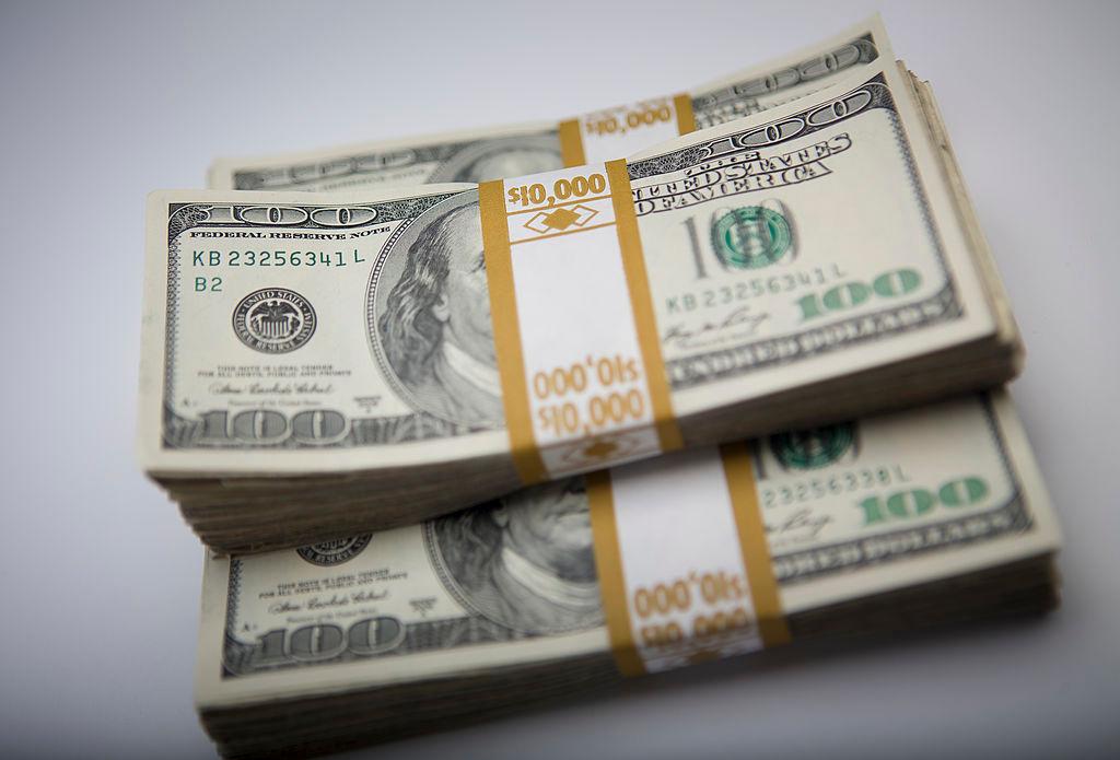 Three stacks of hundred-dollar bills