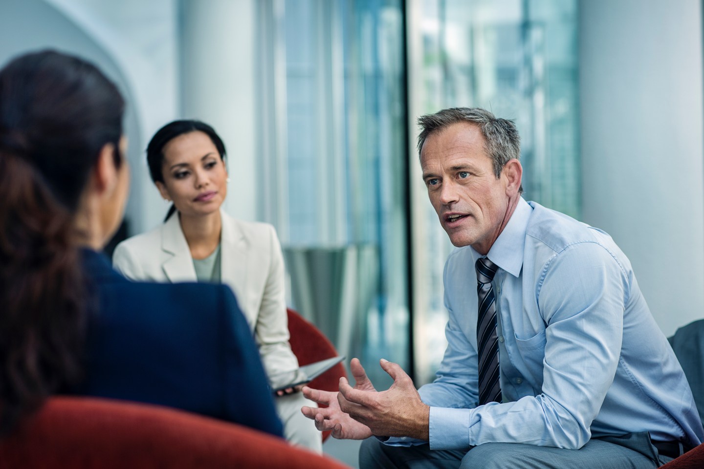Stock photo of businessman discussing strategy with two colleagues