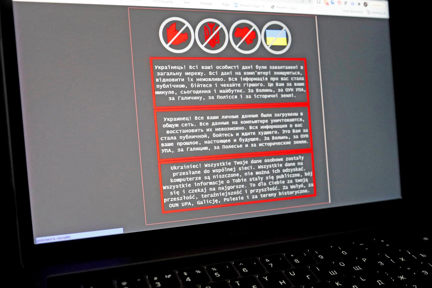 A laptop screen displays a warning message after a cyberattack in Ukraine.