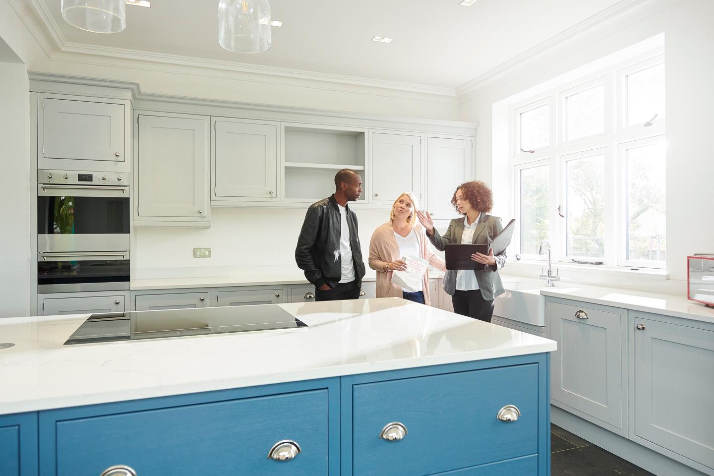 A couple look at a home with a real estate broker
