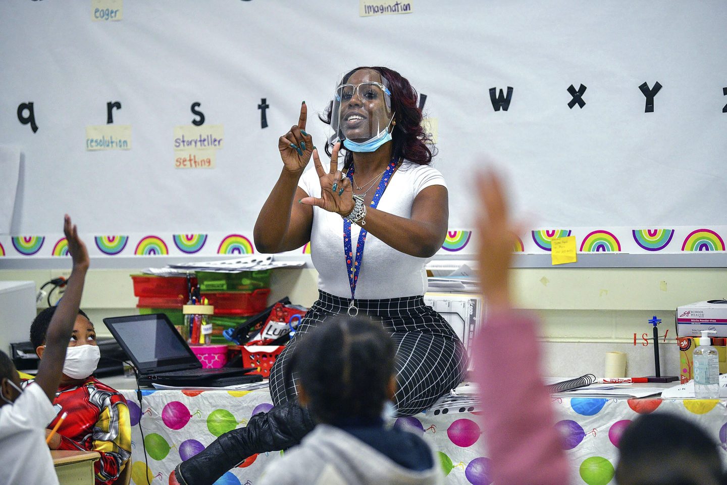 Teacher wearing a mask and face shield in her classroom
