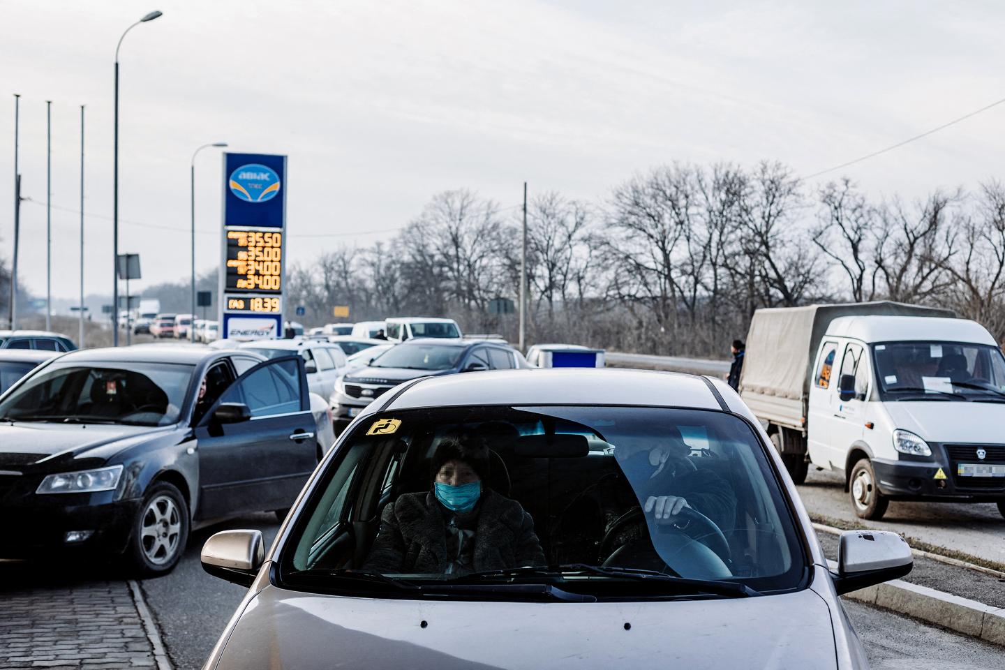 Vehicles drive to a gas station in Kramatorsk, Ukraine on February 24, 2022.