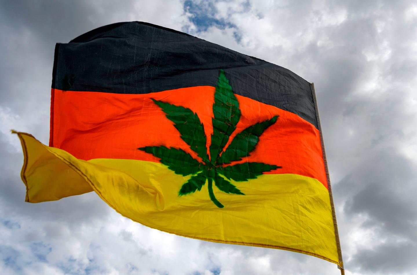 A picture taken on August 10, 2019 in Berlin shows a national flag bearing a marijuana leaf during the 23rd Hanfparade, a traditional German-wide pro-Cannabis march, to ask for its legalisation.