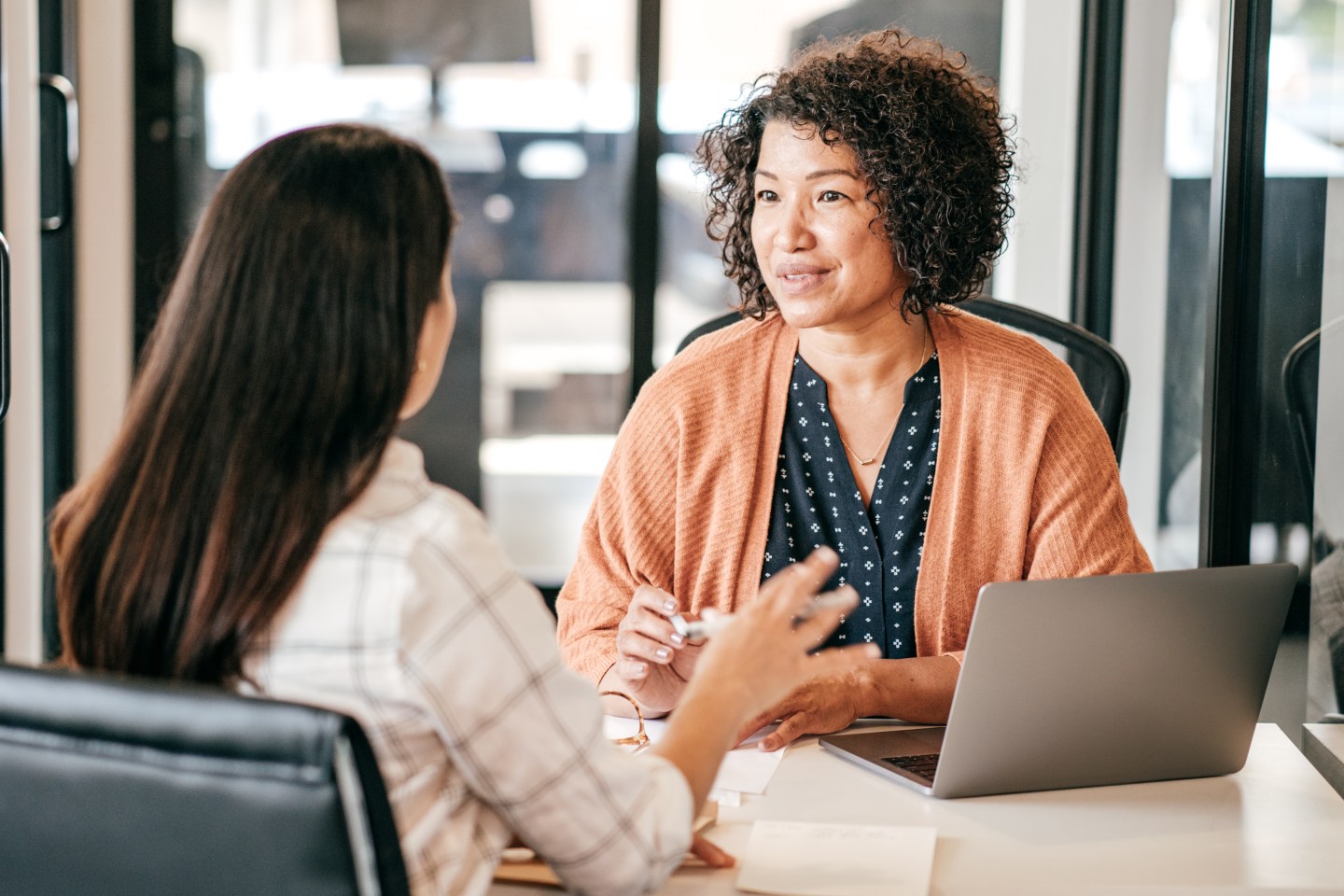 A manager interviews a prospective candidate in an office setting