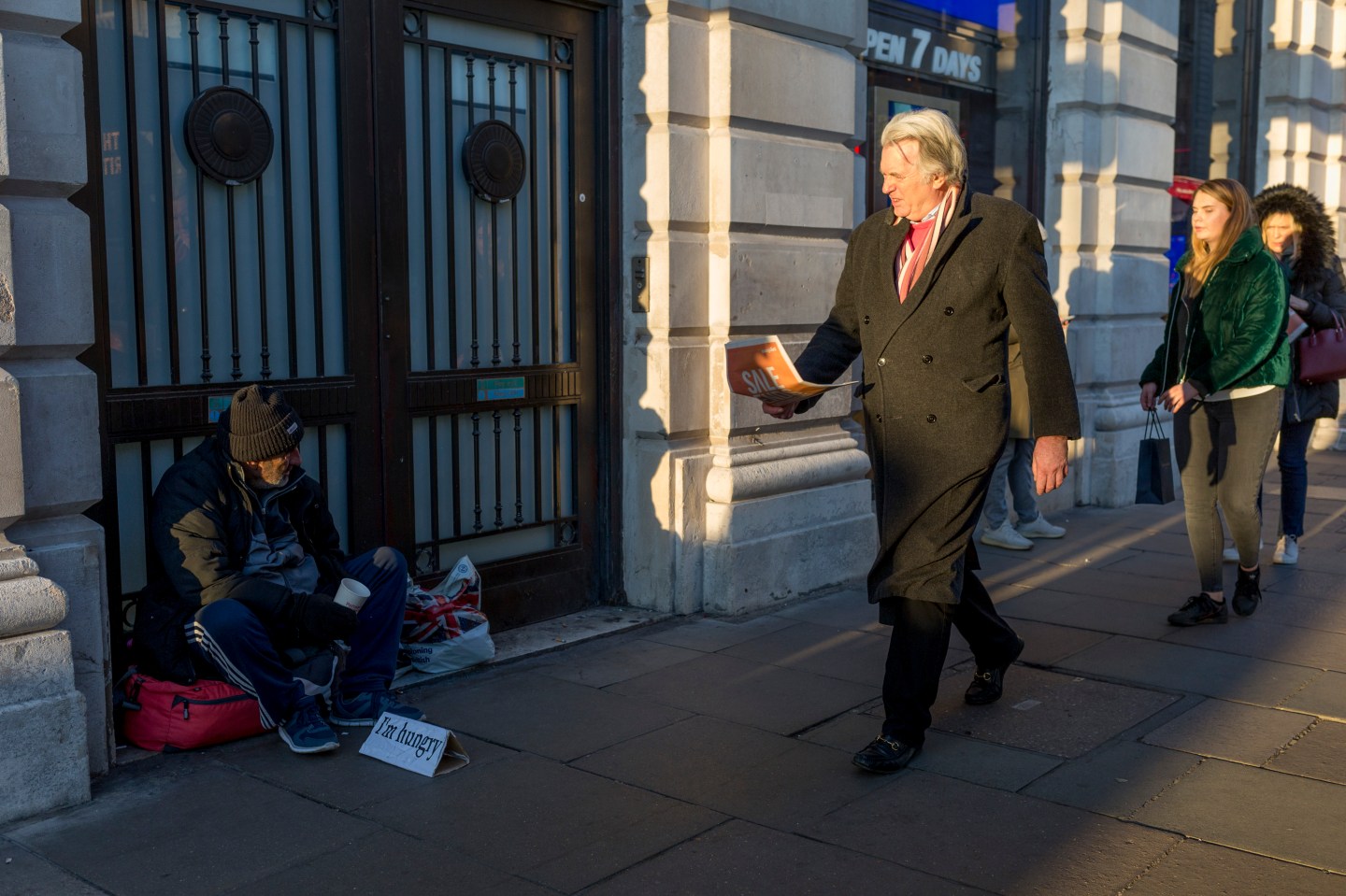 Man walks past homeless person asking for money