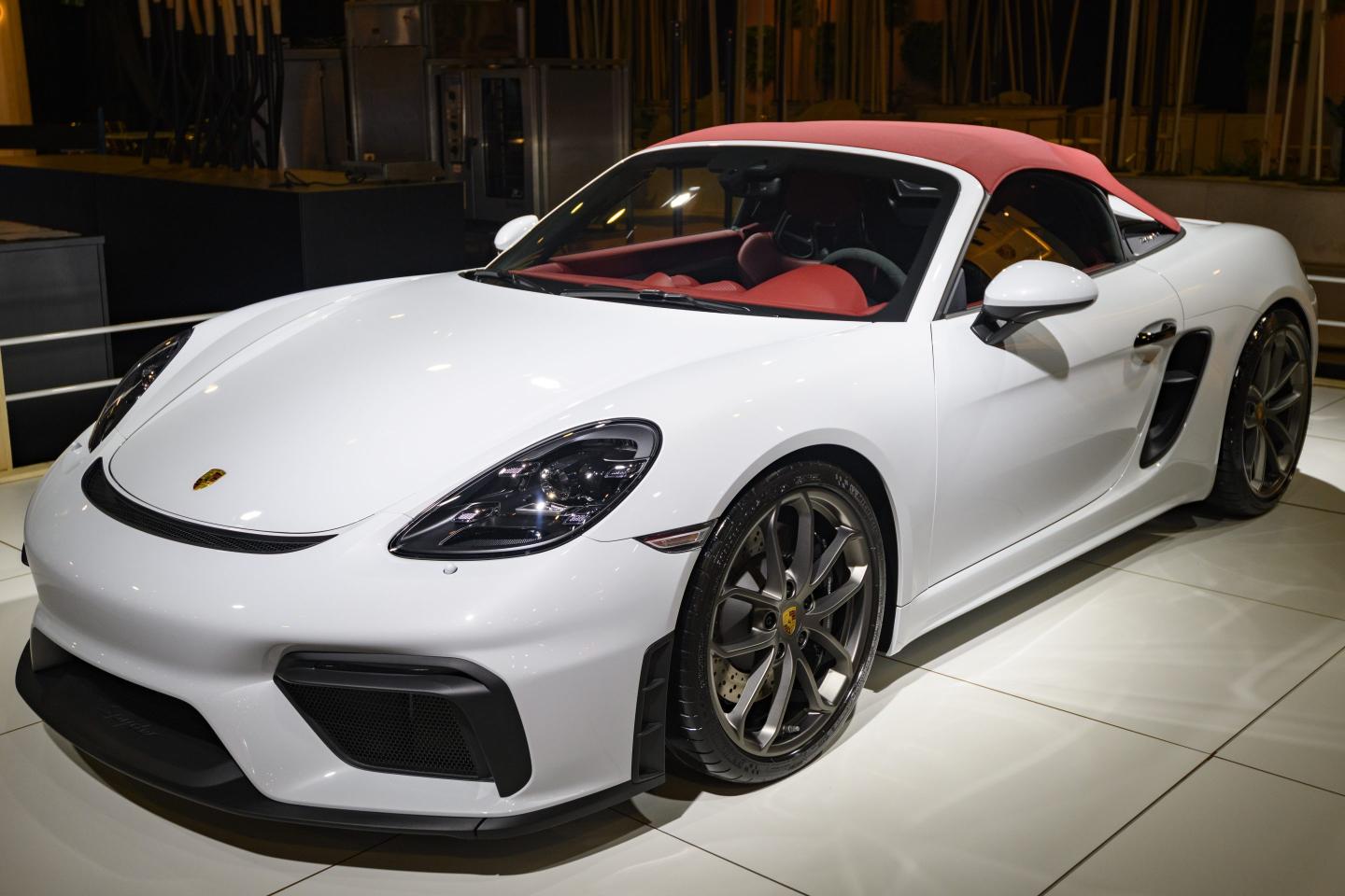 A white Porsche 718 Spyder convertible sports car