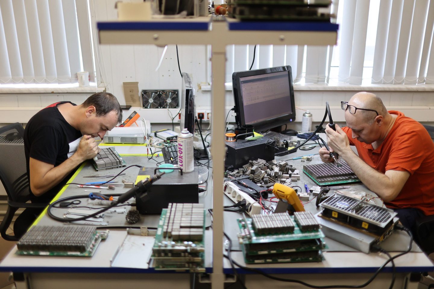 Technicians repair mining hardware inside the 3Logic mining equipment service center, in Moscow, Russia.