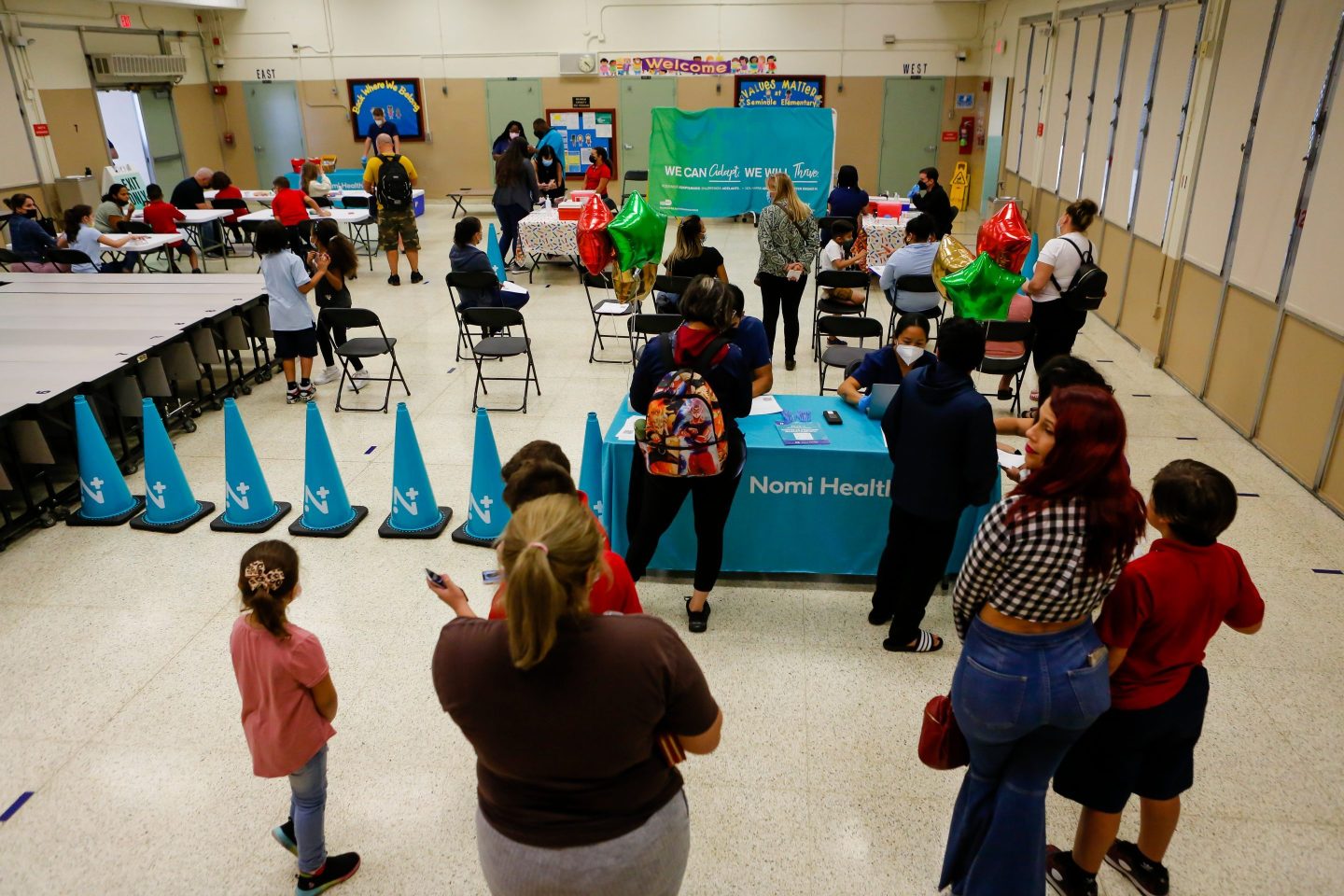 Children arrive at a vaccination site in Florida