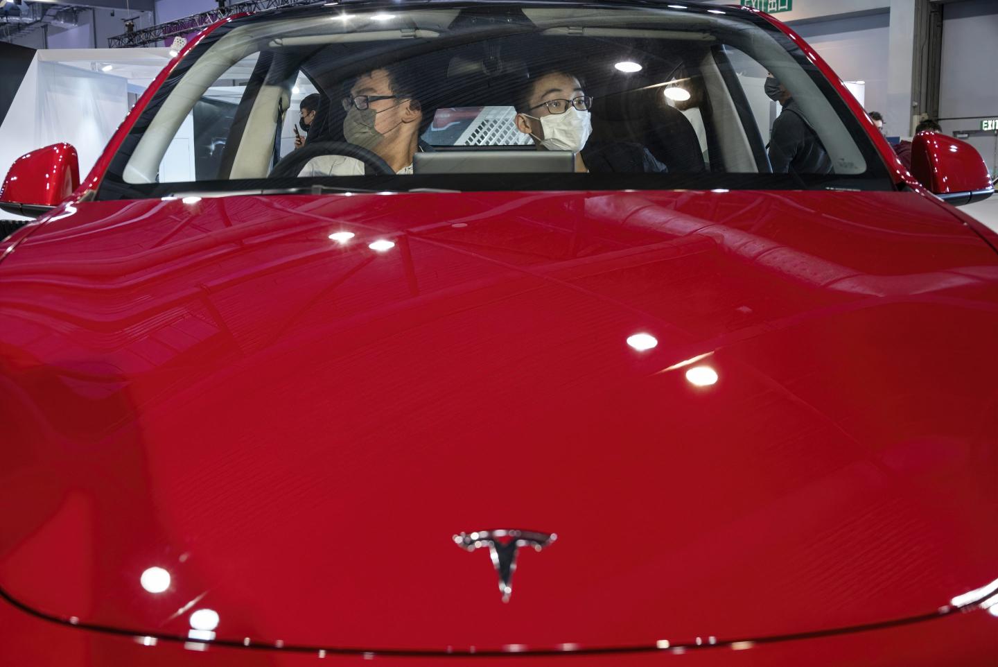 Red Tesla self driving vehicle