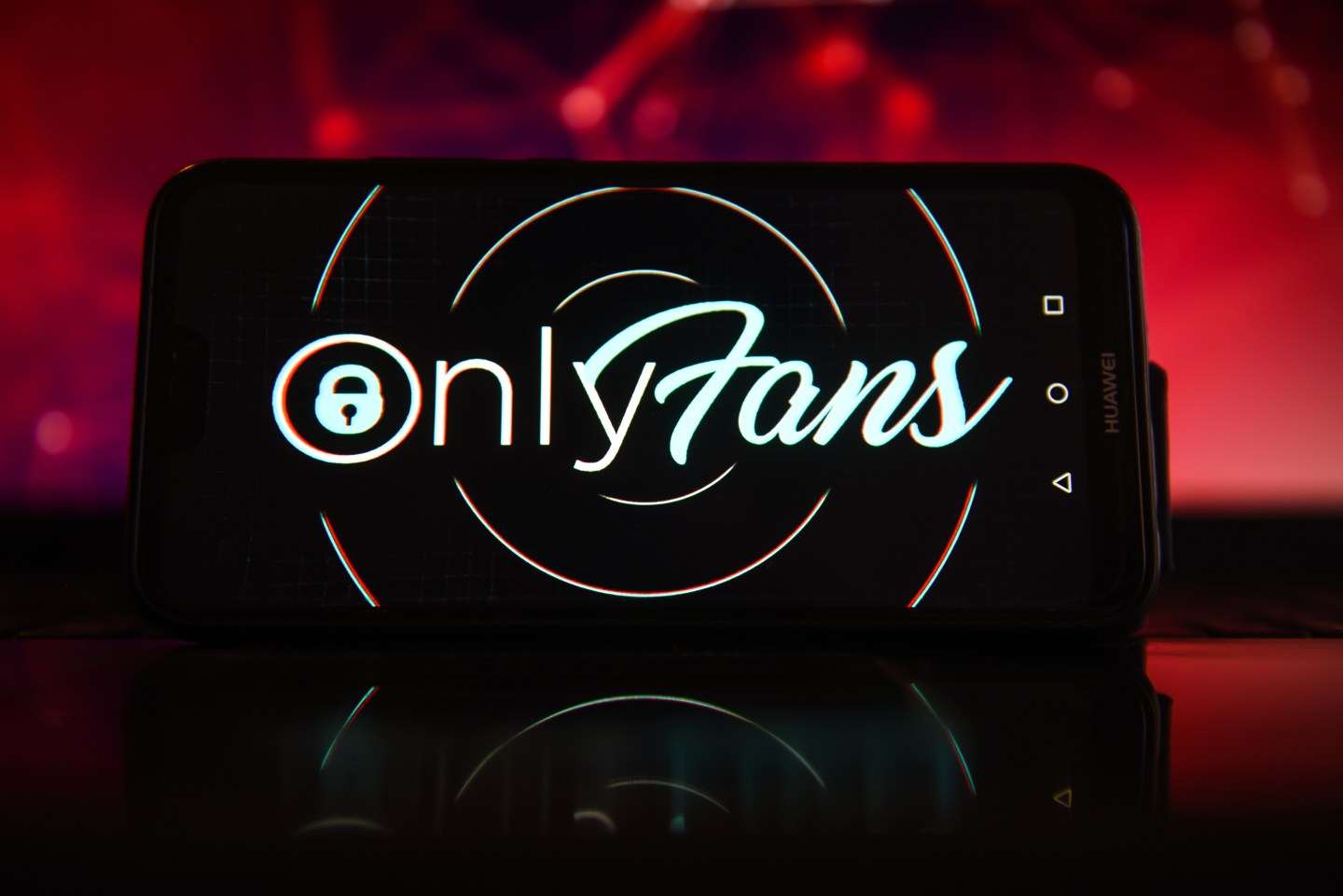 A phone displaying the OnlyFans logo.