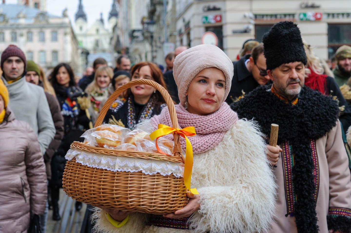 A woman carries a basket of bread
