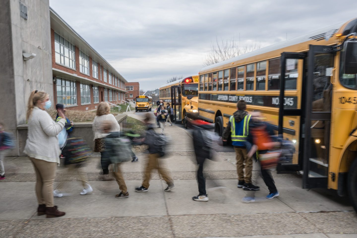 A teacher waves to her students as they get off a bus in Kentucky