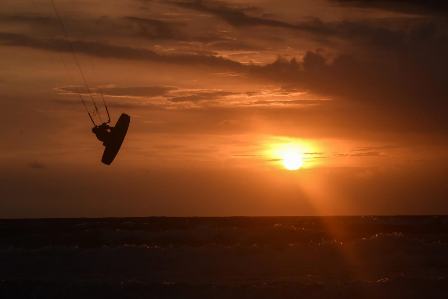 A man kitesurfs at a beach in Kuta on Indonesia's resort island of Bali on January 26, 2022.